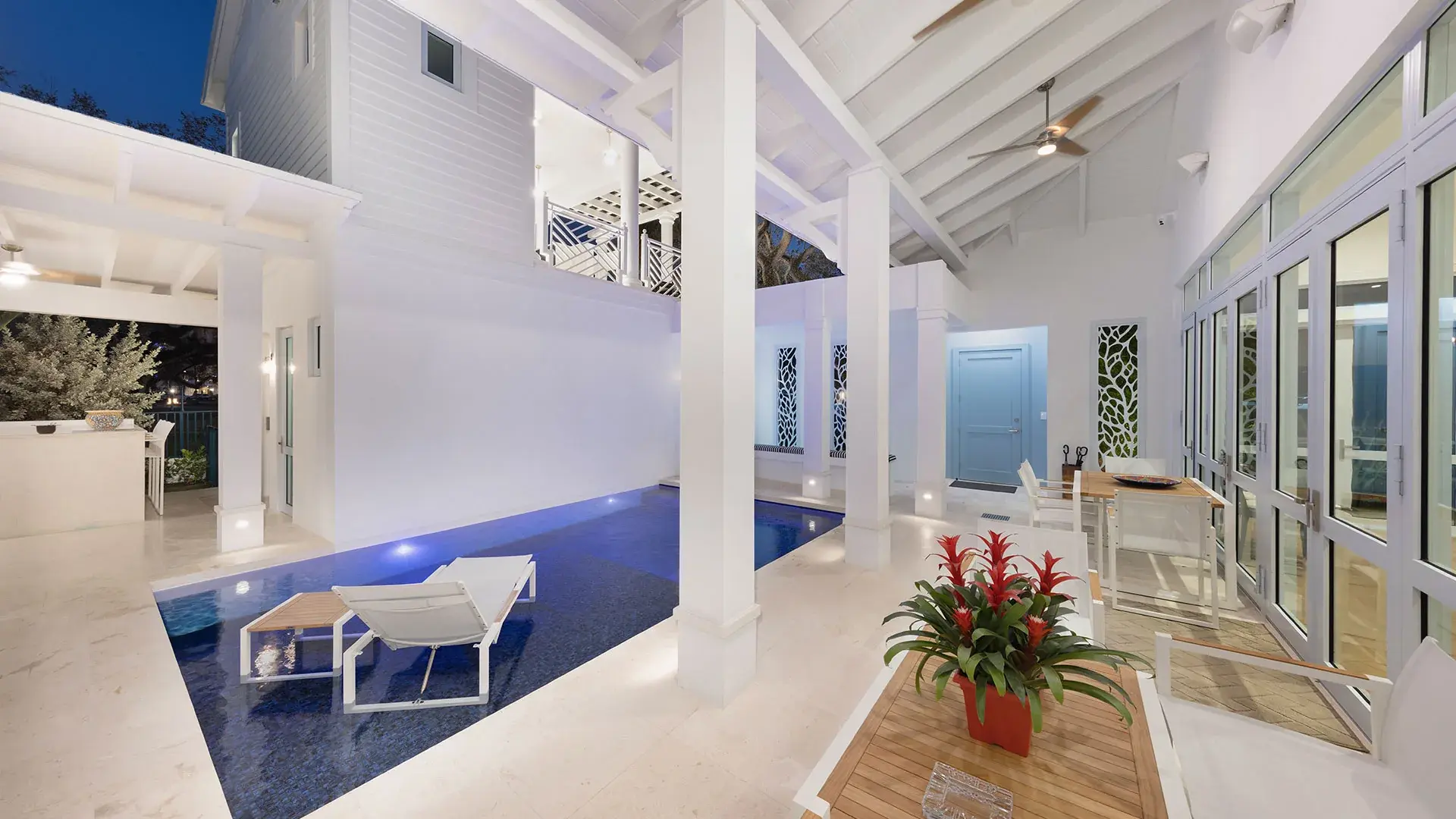 1238 Malaga — side elevation with office windows at dusk